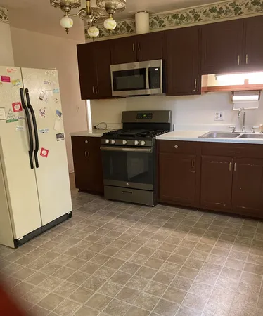 a kitchen with stainless steel appliances a stove a microwave and a refrigerator