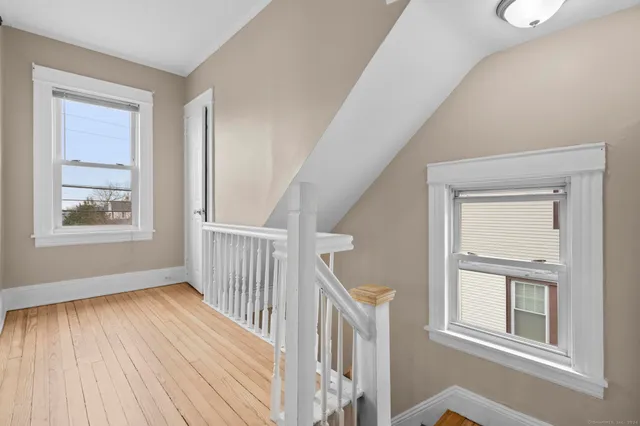 a view of a hallway with wooden floor