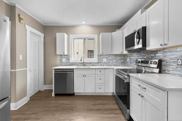 a metallic refrigerator freezer sitting in a kitchen