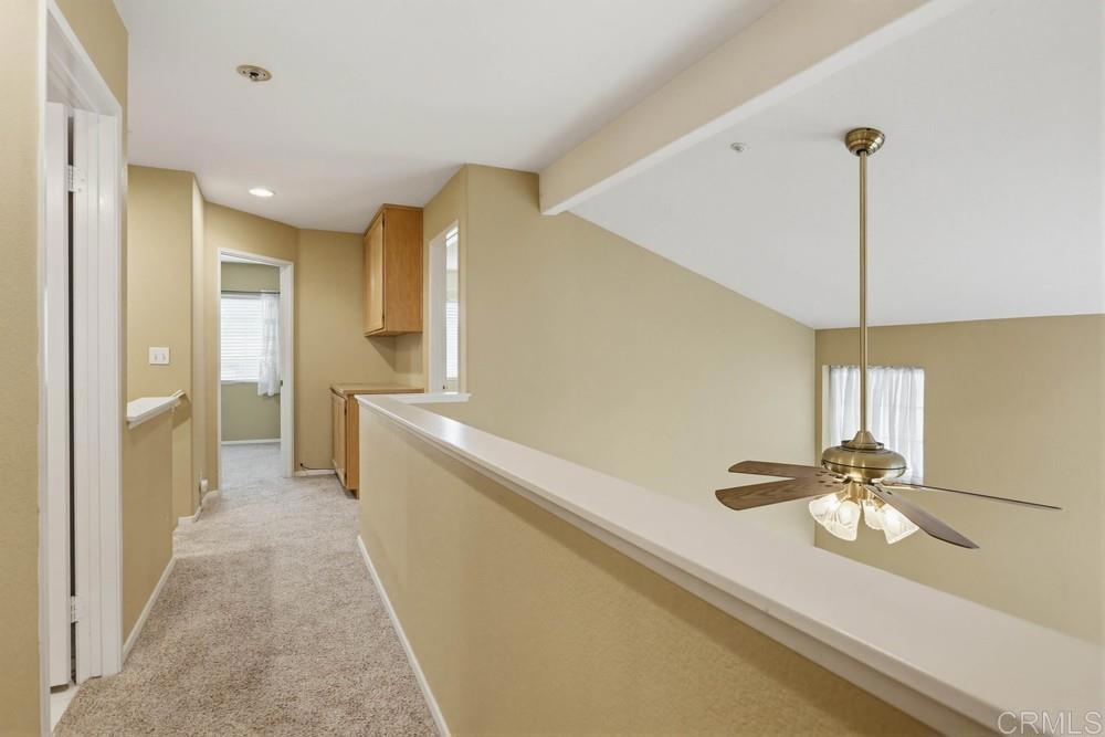 1340 H Street Ramona, CA 92065 - Photo 11 of 27 a view of a hallway with a chandelier