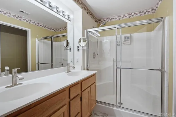 a bathroom with a shower sink and mirror
