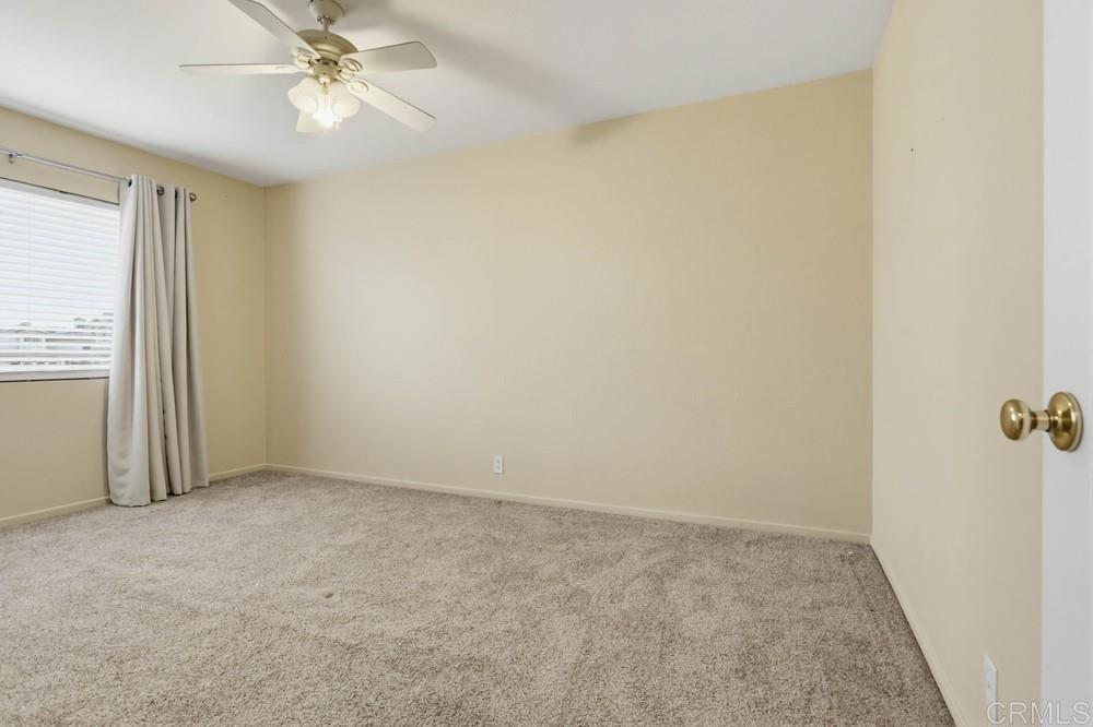 1340 H Street Ramona, CA 92065 - Photo 17 of 27 an empty room with windows and fan