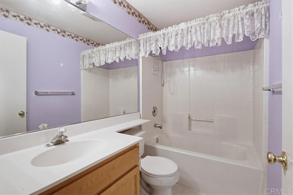 1340 H Street Ramona, CA 92065 - Photo 20 of 27 a bathroom with a sink a toilet a mirror and shower