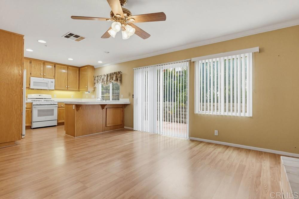 1340 H Street Ramona, CA 92065 - Photo 5 of 27 a view of a kitchen with a stove cabinets a ceiling fan and wooden floor