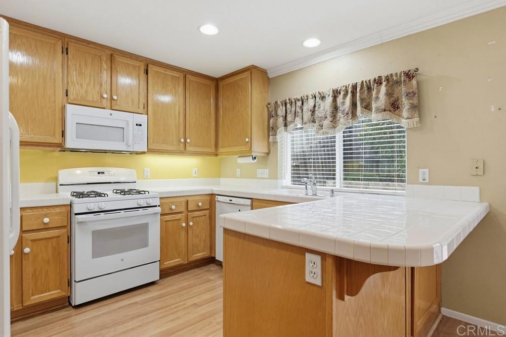 1340 H Street Ramona, CA 92065 - Photo 6 of 27 a kitchen with a stove a sink and cabinets
