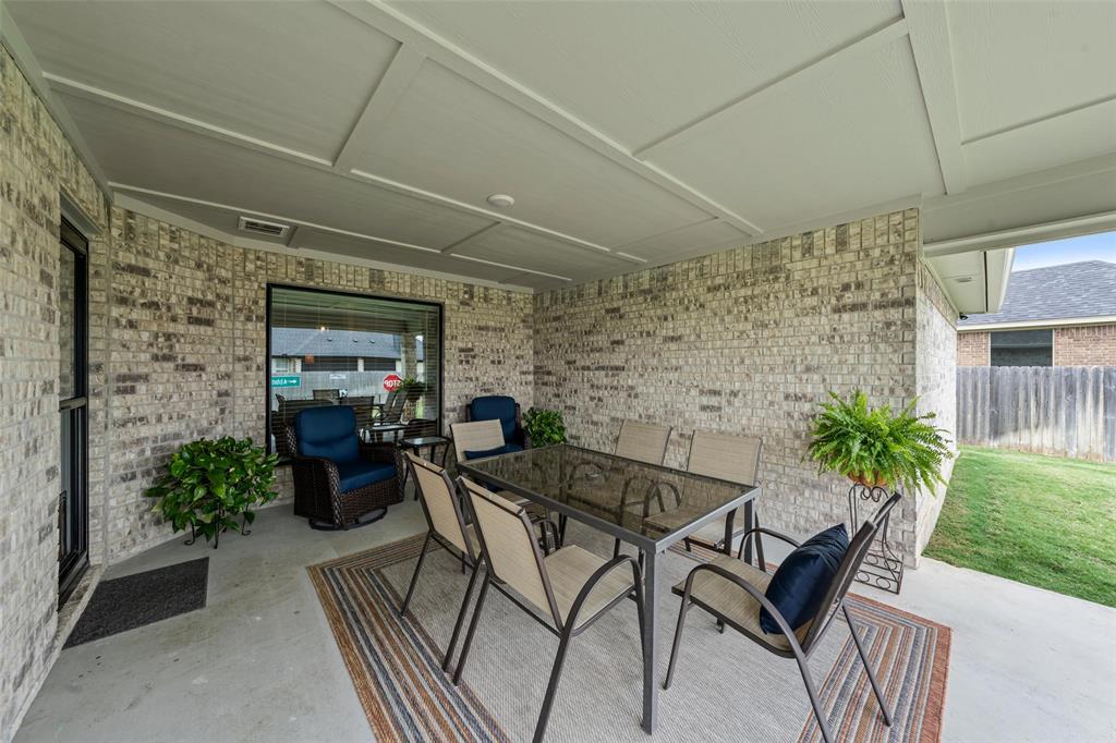 828 Agile Street Hewitt, TX 76643 - Photo 27 of 30 a view of a patio with table and chairs and potted plants