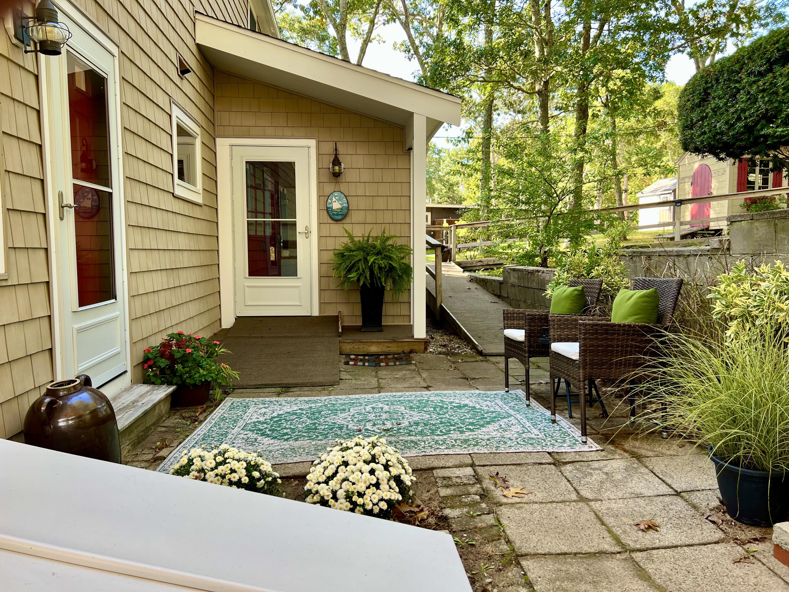 72 Captains Row Mashpee, MA 02649 - Photo 31 of 40 a view of a house with backyard and sitting area