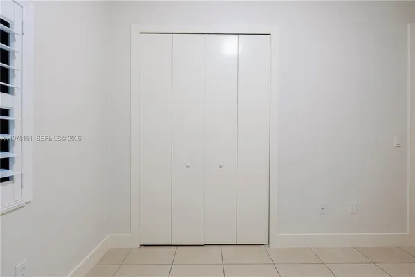 a bathroom with a granite countertop sink mirror vanity bathtub and toilet