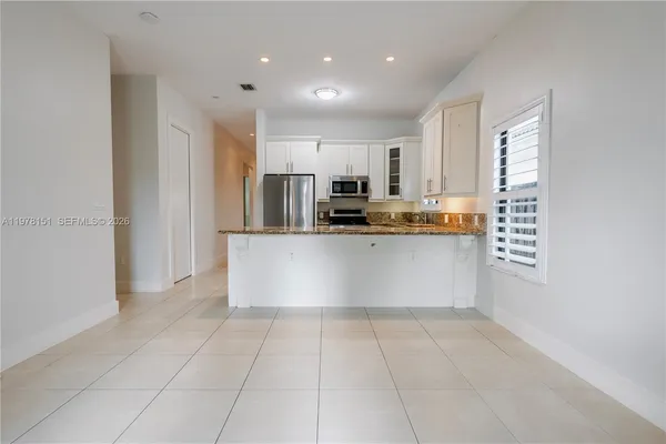 a kitchen with stainless steel appliances a refrigerator sink and microwave