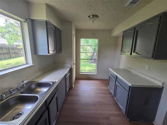 a kitchen with a sink stove and microwave