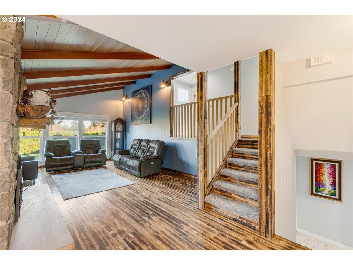 16507 Northeast 30th Court Ridgefield, WA 98642 - Photo 16 of 48 a view of a livingroom with wooden floor and stairs