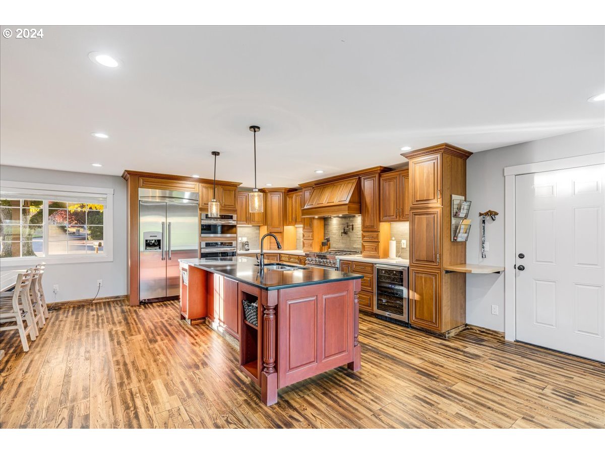 16507 Northeast 30th Court Ridgefield, WA 98642 - Photo 19 of 48 a open kitchen with stainless steel appliances granite countertop a stove refrigerator and cabinets
