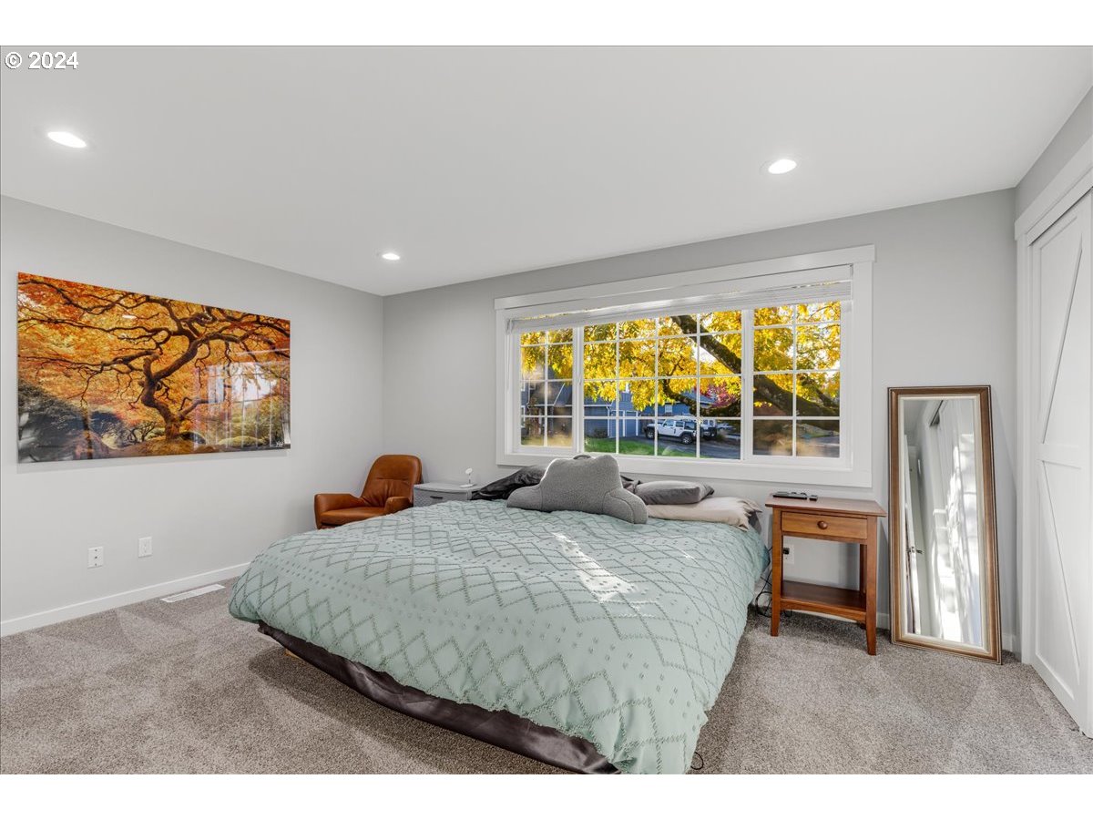 16507 Northeast 30th Court Ridgefield, WA 98642 - Photo 23 of 48 a bedroom with a bed and glass windows