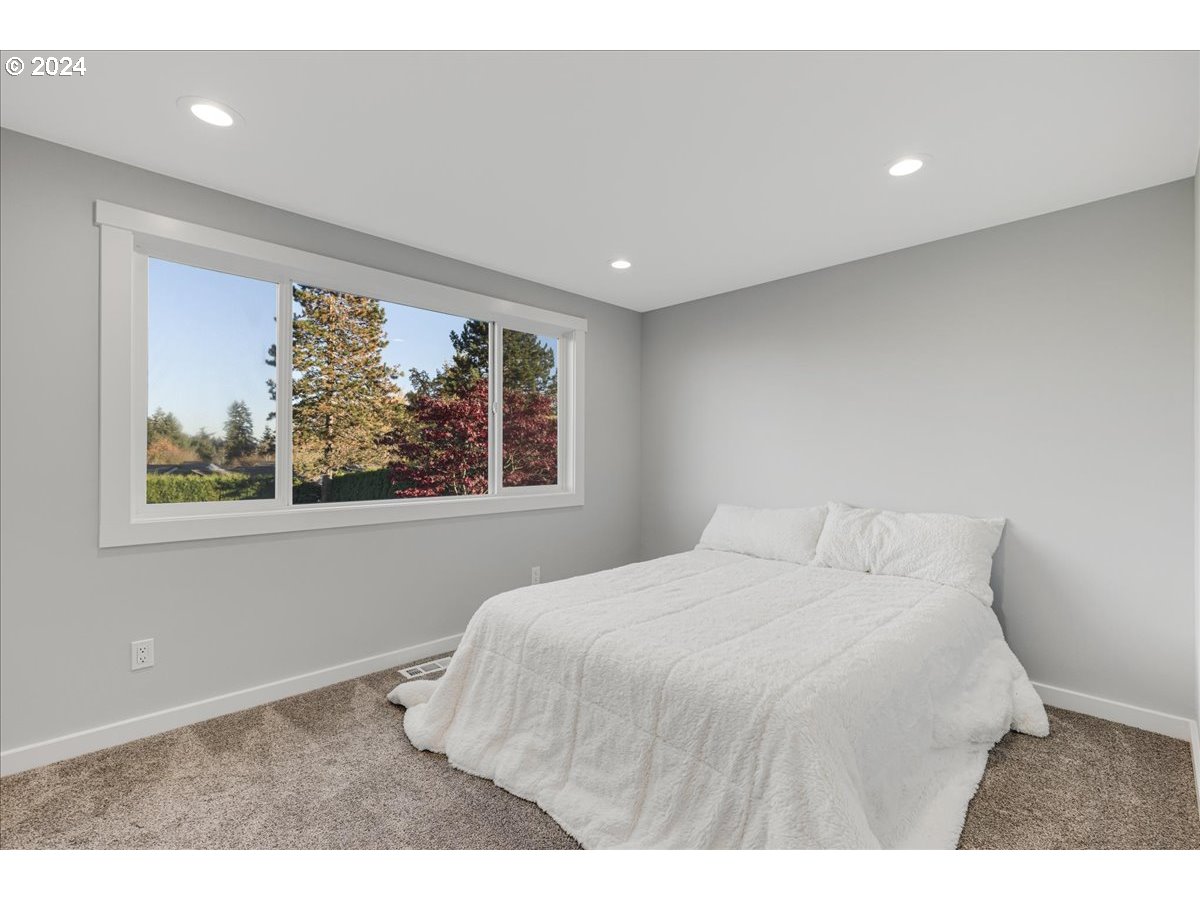 16507 Northeast 30th Court Ridgefield, WA 98642 - Photo 30 of 48 a bedroom with a bed and a large window