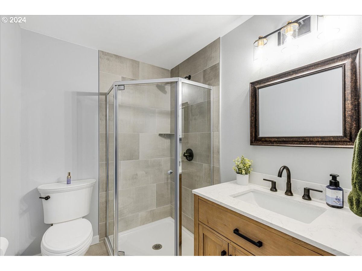 16507 Northeast 30th Court Ridgefield, WA 98642 - Photo 31 of 48 a bathroom with a sink toilet a mirror and shower