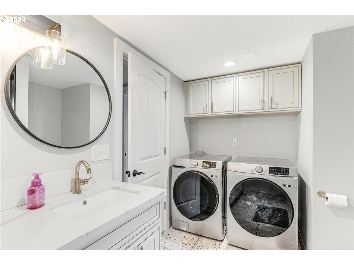 16507 Northeast 30th Court Ridgefield, WA 98642 - Photo 37 of 48 a bathroom with a sink mirror washer and dryer