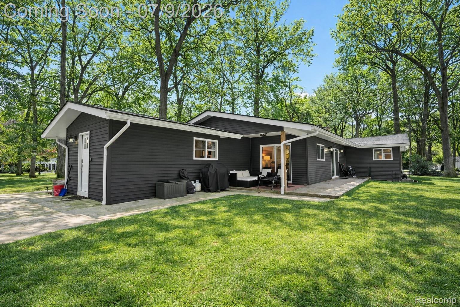 2566 Harrington Road Rochester, MI 48307 - Photo 64 of 64 Back of property with a lawn and a patio