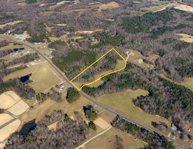 an aerial view of a house with a yard and lake view