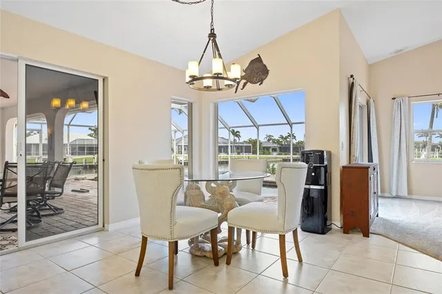 a dining room with furniture a chandelier and wooden floor