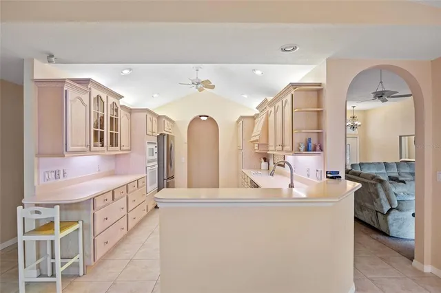 a open kitchen with stainless steel appliances granite countertop a sink and cabinets