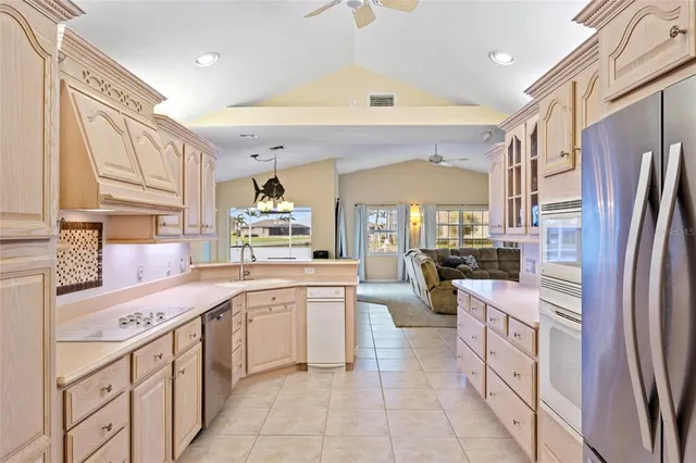 a kitchen with white cabinets and white appliances