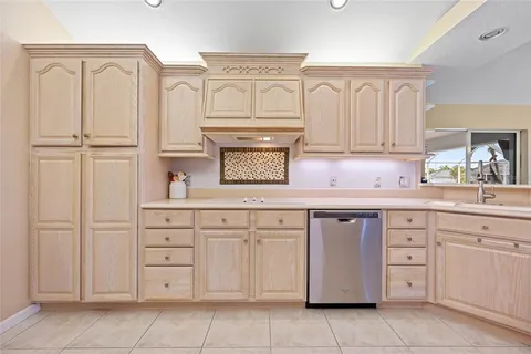 a kitchen with cabinets and stainless steel appliances
