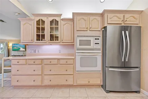 a bedroom with a bed lamp and a large mirror