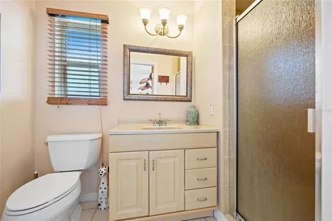 an aerial view of ocean and residential houses with outdoor space