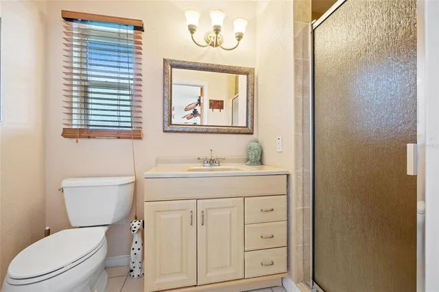 an aerial view of ocean and residential houses with outdoor space