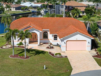 an aerial view of ocean and residential houses with outdoor space