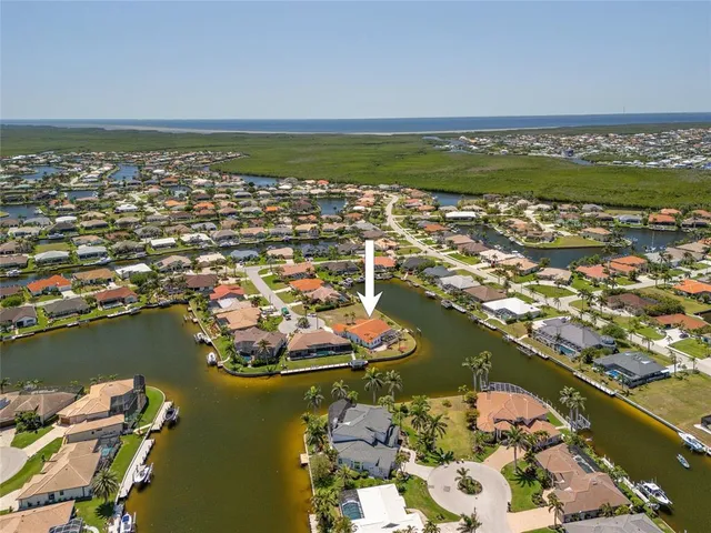 an aerial view of residential houses with outdoor space and lake view