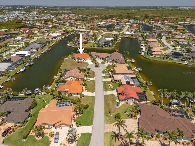 an aerial view of a house with a lake view