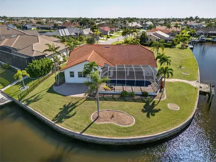 a view of a house with swimming pool and sitting area