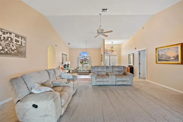 a living room with furniture and a chandelier