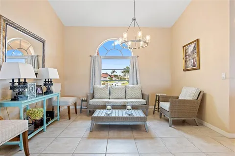 a living room with furniture and a chandelier