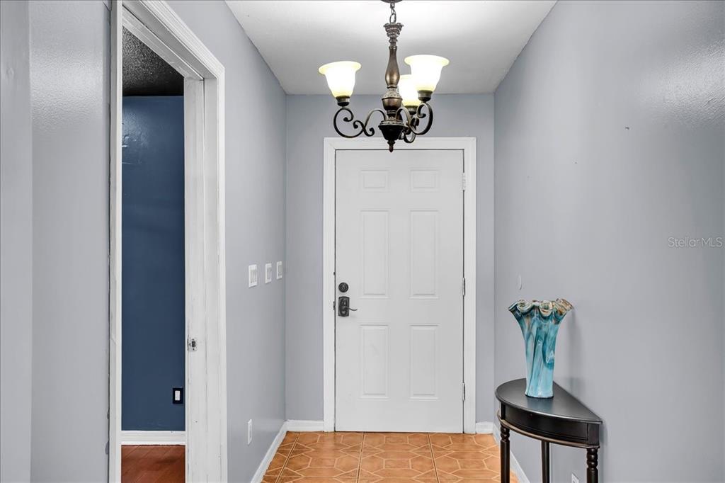 6124 Lynn Road Tampa, FL 33625 - Photo 36 of 84 a view of a hallway with chandelier and front door
