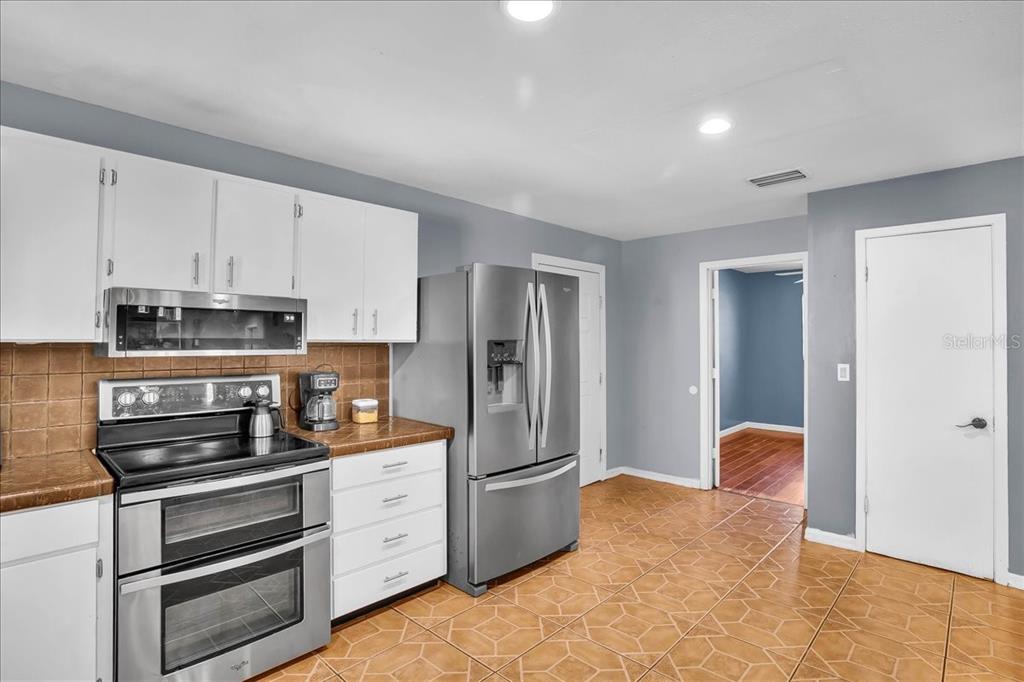 6124 Lynn Road Tampa, FL 33625 - Photo 46 of 84 a kitchen with stainless steel appliances granite countertop a refrigerator and a stove top oven