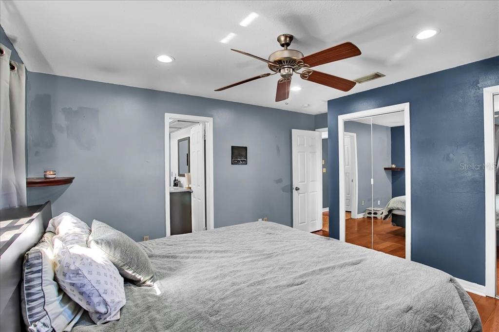 6124 Lynn Road Tampa, FL 33625 - Photo 58 of 84 a bedroom with bed and a chandelier