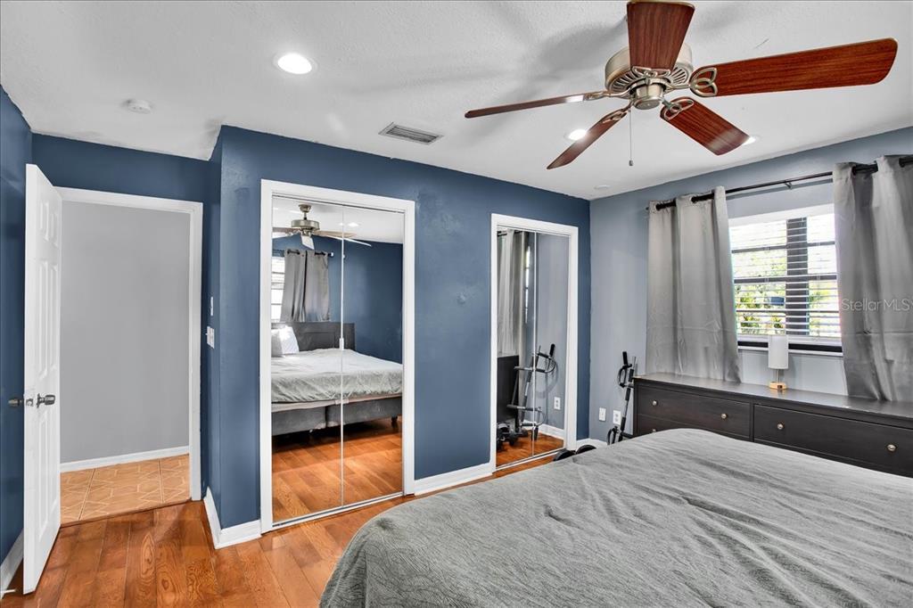 6124 Lynn Road Tampa, FL 33625 - Photo 59 of 84 a bedroom with a bed and a chandelier