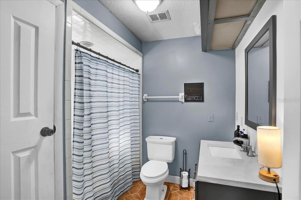 6124 Lynn Road Tampa, FL 33625 - Photo 60 of 84 a bathroom with a sink a toilet and a mirror