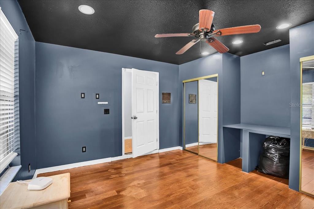 6124 Lynn Road Tampa, FL 33625 - Photo 65 of 84 a bedroom with a bed and a chandelier