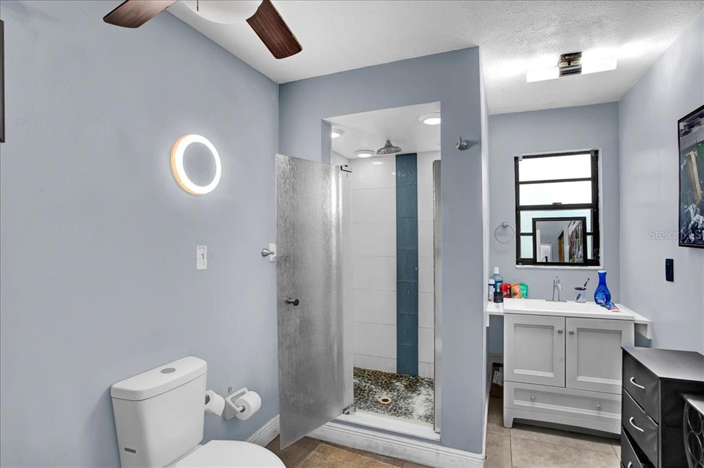 6124 Lynn Road Tampa, FL 33625 - Photo 80 of 84 a bathroom with a toilet sink vanity granite and shower