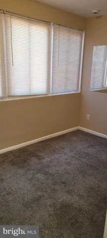 a view of a room with window and wooden floor
