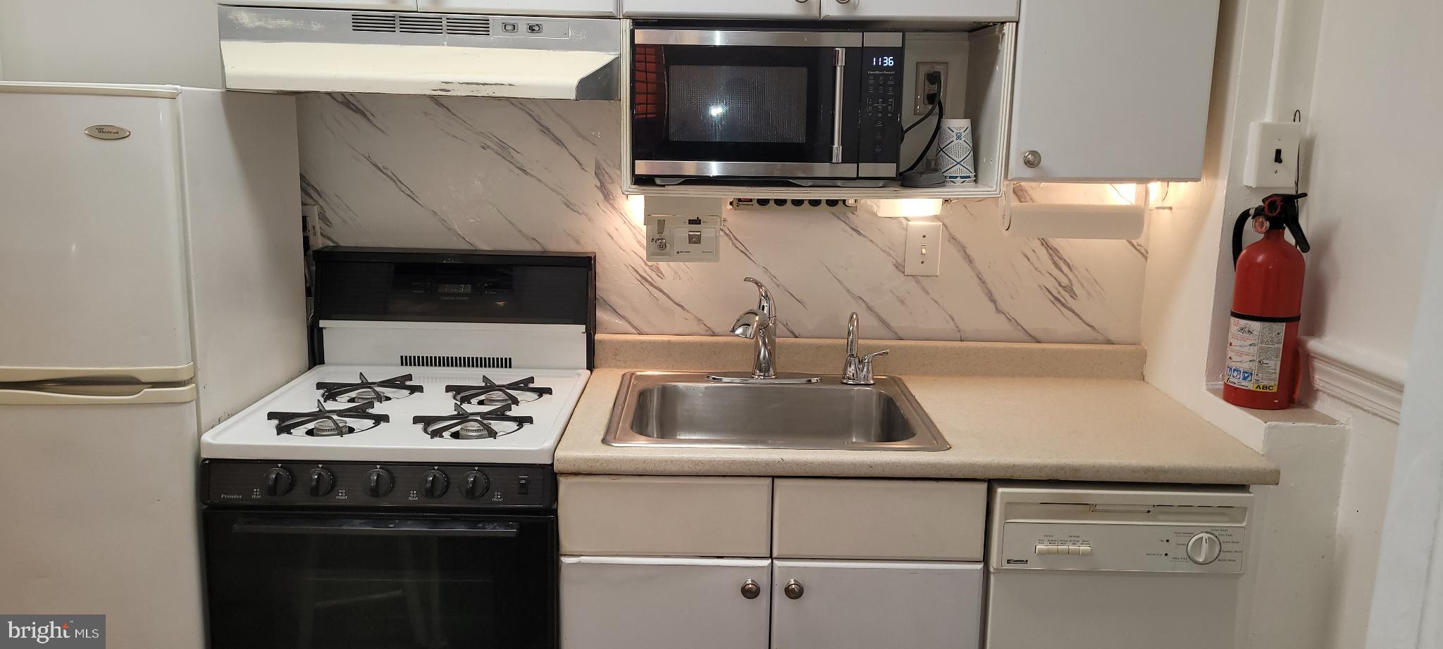 744 Hilltop Terrace Southeast Washington, DC 20019 - Photo 20 of 30 a kitchen with a sink and cabinets