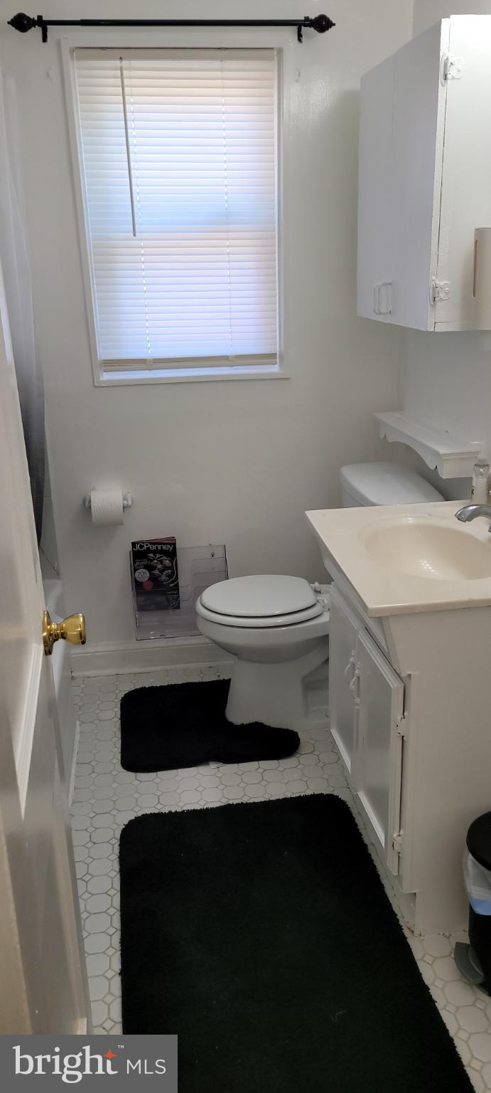 744 Hilltop Terrace Southeast Washington, DC 20019 - Photo 22 of 30 a bathroom with a sink a toilet and mirror