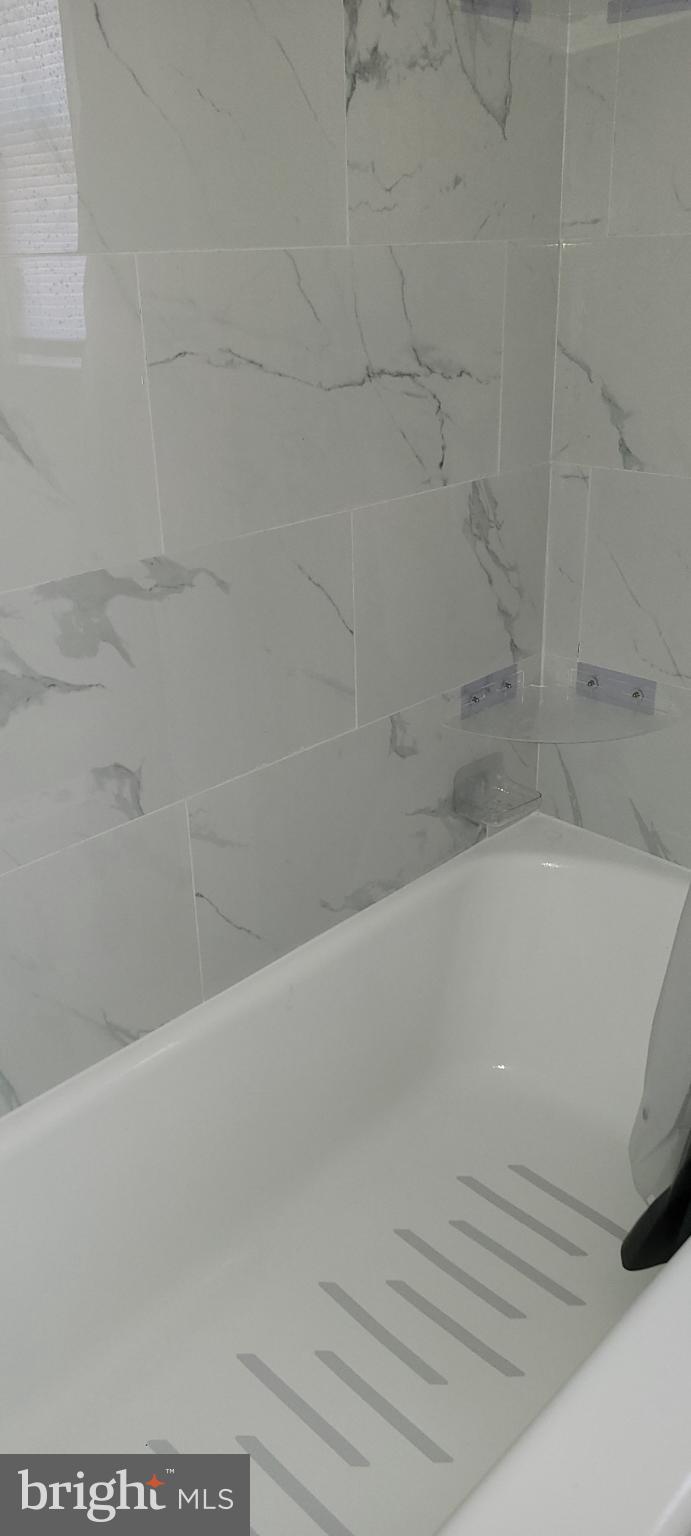 744 Hilltop Terrace Southeast Washington, DC 20019 - Photo 23 of 30 a bathroom with a bathtub