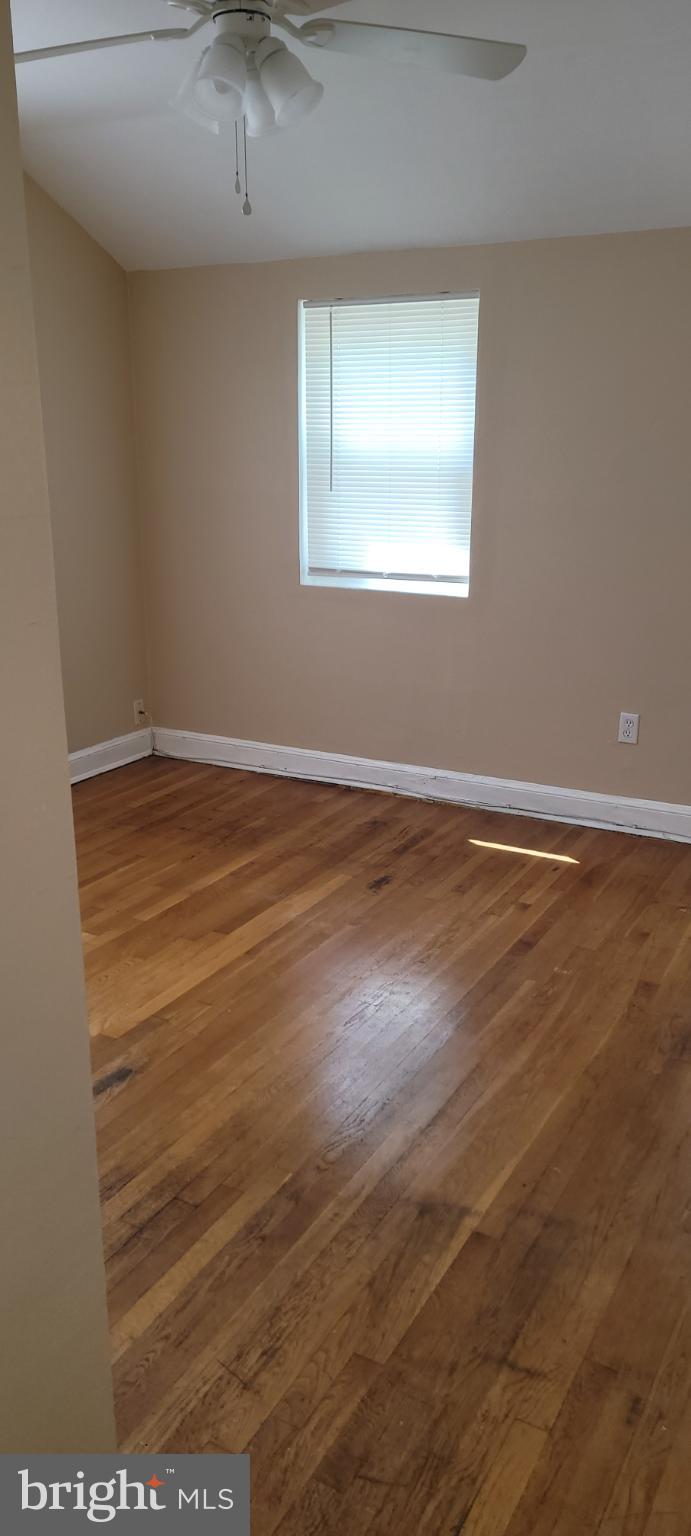 744 Hilltop Terrace Southeast Washington, DC 20019 - Photo 27 of 30 an empty room with wooden floor and windows