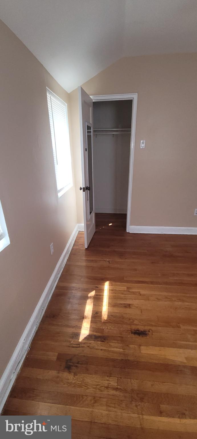 744 Hilltop Terrace Southeast Washington, DC 20019 - Photo 5 of 30 a view of an empty room with wooden floor and a window