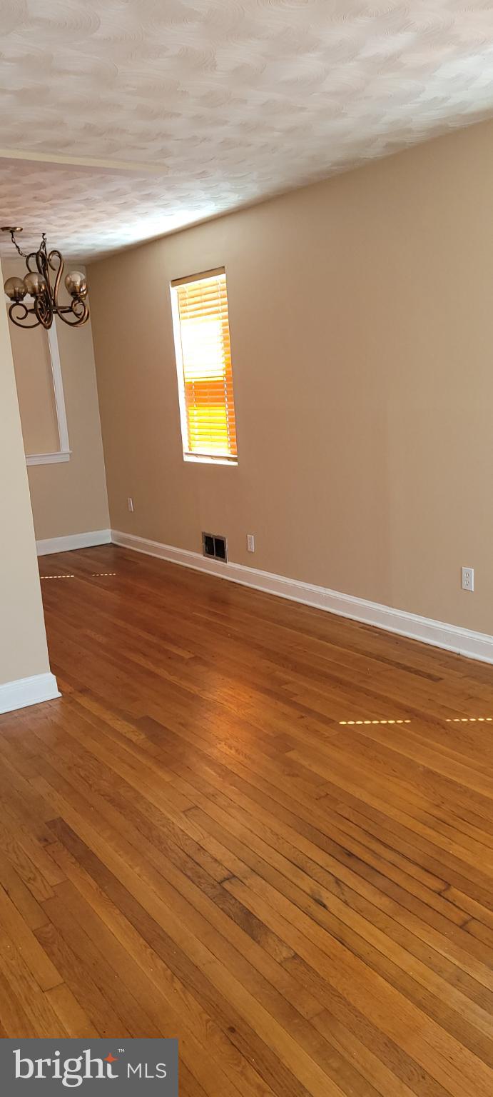 744 Hilltop Terrace Southeast Washington, DC 20019 - Photo 10 of 30 a view of an empty room with wooden floor and a window
