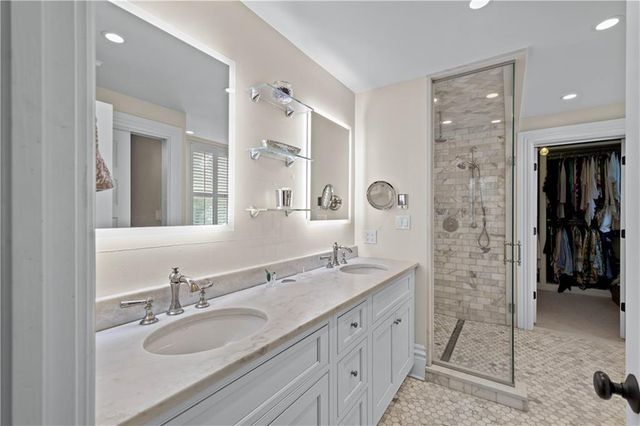 a bathroom with a granite countertop sink mirror and double